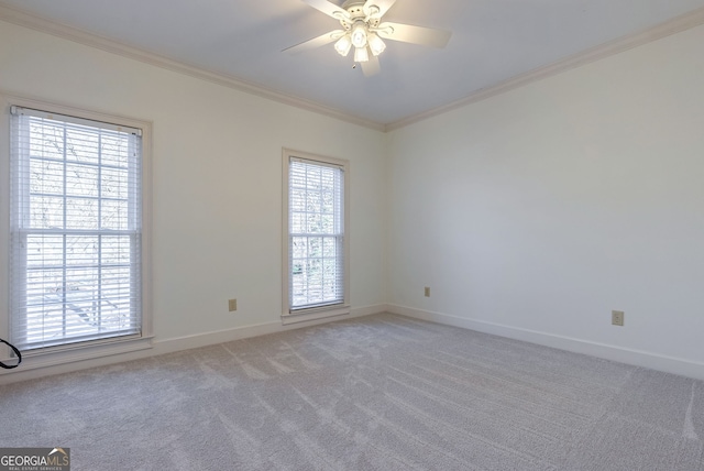 carpeted empty room with crown molding and ceiling fan