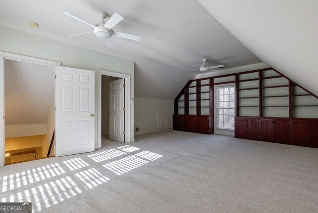 unfurnished bedroom with light carpet, ornamental molding, a closet, and ceiling fan