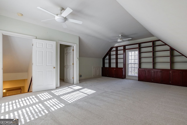 additional living space featuring ceiling fan, vaulted ceiling, and light carpet