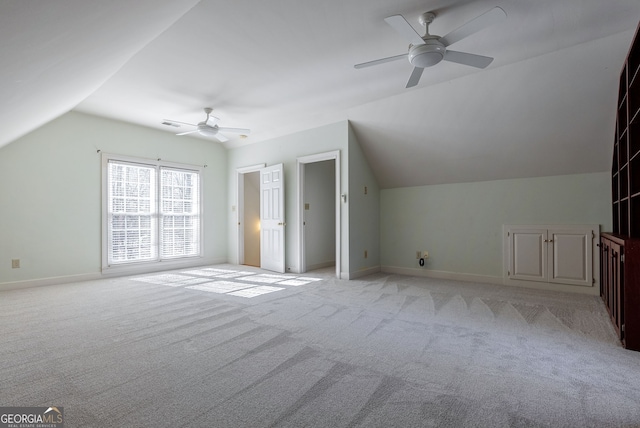 bonus room with ceiling fan, vaulted ceiling, and light carpet