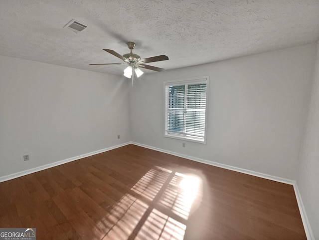 2268 Turtle Club Dr NE, Marietta, GA 30066 - empty room with ceiling fan, dark wood-style flooring, and a textured ceiling