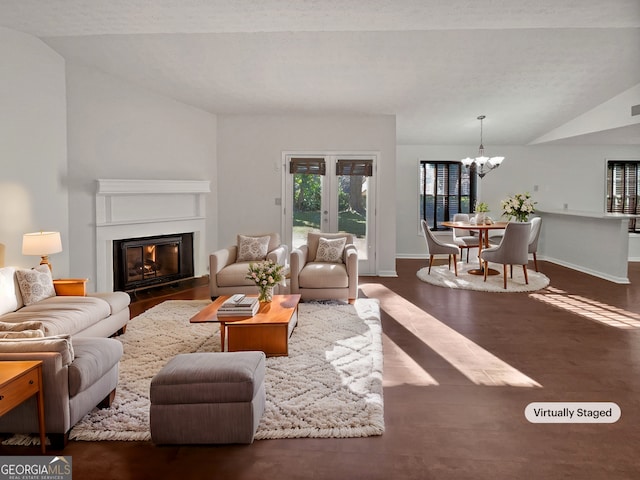 2268 Turtle Club Dr NE, Marietta, GA 30066 - living room featuring lofted ceiling, a chandelier, a glass covered fireplace, and wood finished floors