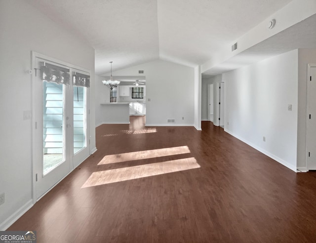 2268 Turtle Club Dr NE, Marietta, GA 30066 - unfurnished living room featuring dark wood finished floors, plenty of natural light, vaulted ceiling, and a chandelier