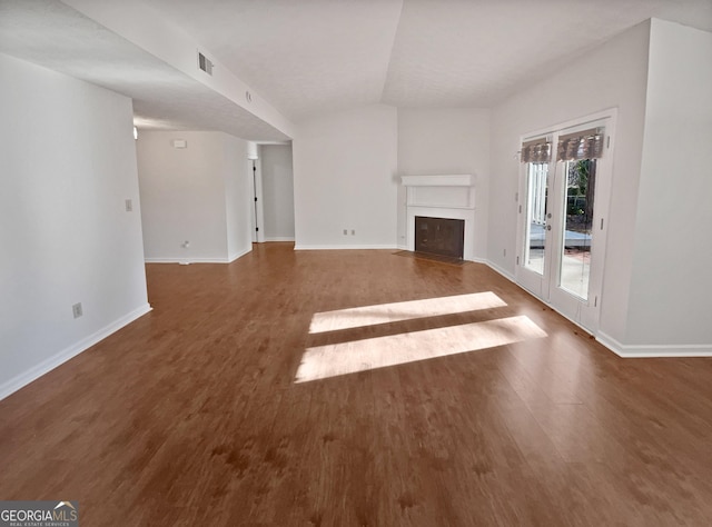 2268 Turtle Club Dr NE, Marietta, GA 30066 - unfurnished living room featuring a fireplace with flush hearth, wood finished floors, and vaulted ceiling