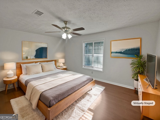 2268 Turtle Club Dr NE, Marietta, GA 30066 - bedroom featuring wood finished floors, a textured ceiling, and ceiling fan
