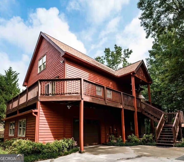 rear view of house with a wooden deck