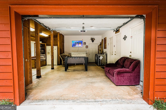 garage with white fridge with ice dispenser