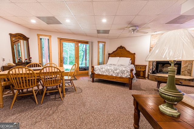 bedroom with carpet floors, a paneled ceiling, and ceiling fan