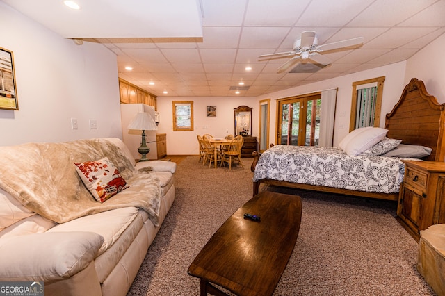 bedroom with ceiling fan, carpet, a drop ceiling, access to outside, and french doors