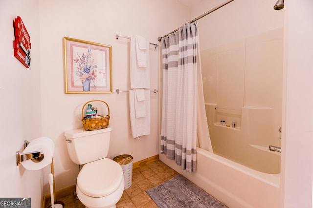 bathroom with shower / bath combo and toilet