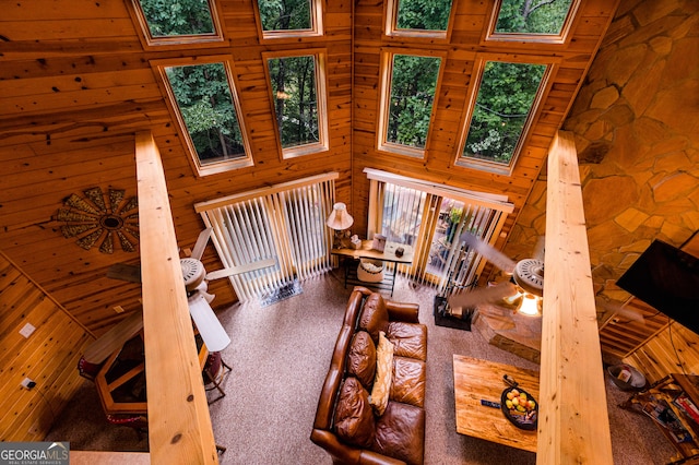 interior space with carpet, wood ceiling, and high vaulted ceiling