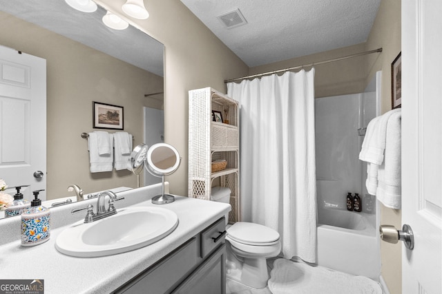 full bathroom featuring shower / bathtub combination with curtain, vanity, toilet, and a textured ceiling