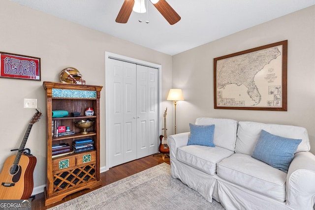 living room featuring dark hardwood / wood-style floors and ceiling fan