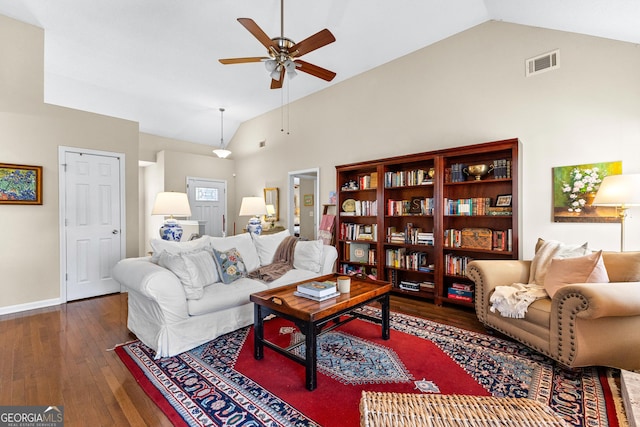 living room featuring lofted ceiling, dark wood-type flooring, and ceiling fan