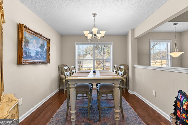 dining room with dark hardwood / wood-style floors, a wealth of natural light, and an inviting chandelier