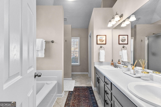 bathroom featuring tile patterned flooring, vanity, independent shower and bath, and a textured ceiling