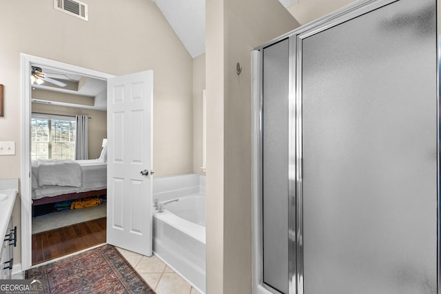 bathroom featuring lofted ceiling, tile patterned floors, independent shower and bath, and ceiling fan