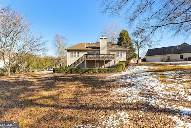 snow covered house featuring a deck