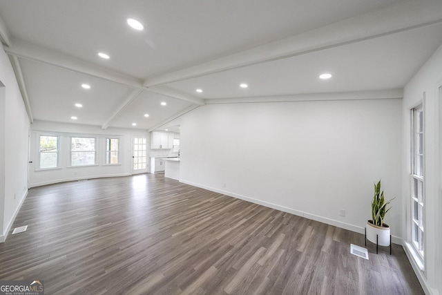 unfurnished living room with lofted ceiling with beams and dark hardwood / wood-style flooring