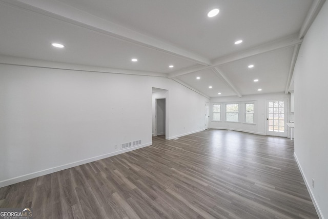 unfurnished living room featuring dark hardwood / wood-style flooring and vaulted ceiling with beams