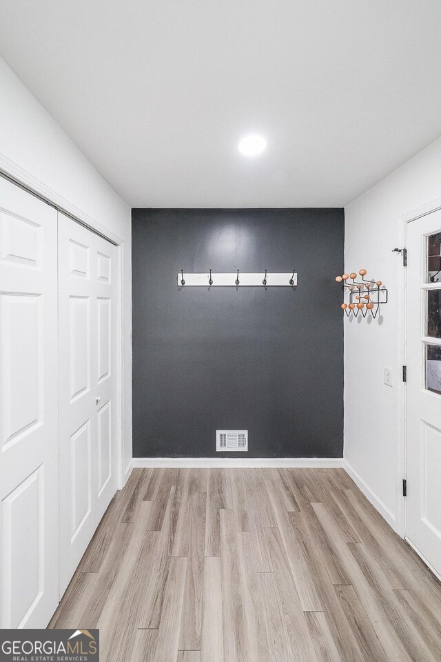 interior space with light hardwood / wood-style floors and a closet