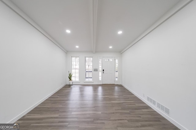 entryway featuring dark hardwood / wood-style floors and beam ceiling