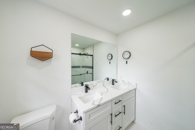 bathroom with walk in shower, tile patterned floors, vanity, and toilet