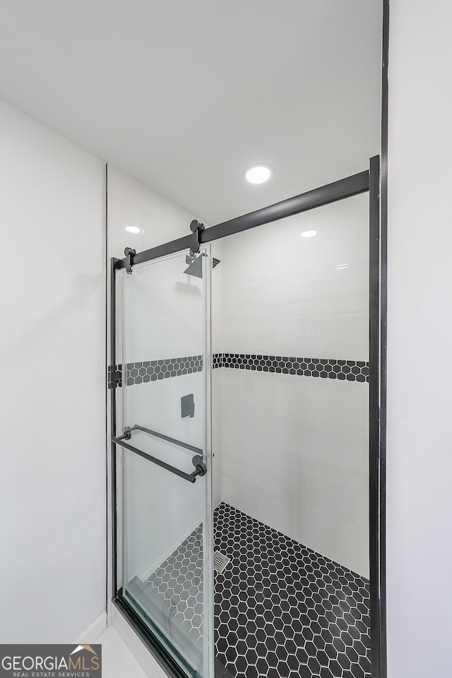 bathroom with a shower with shower door