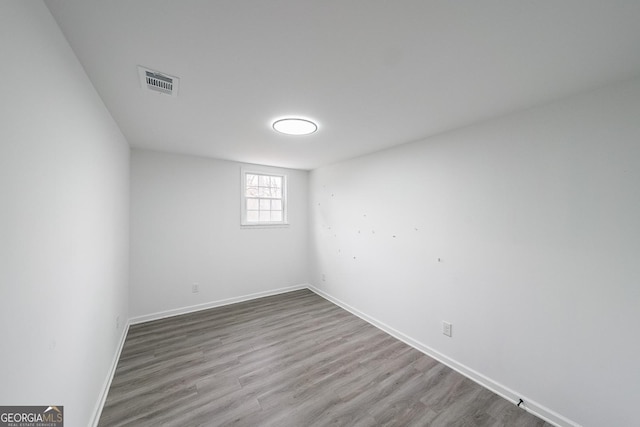 empty room with hardwood / wood-style floors