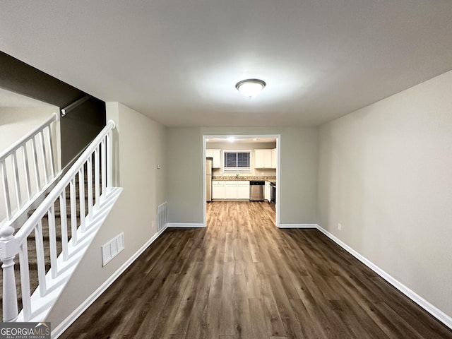 unfurnished living room featuring dark hardwood / wood-style floors