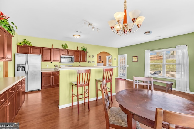 dining space featuring an inviting chandelier and dark hardwood / wood-style floors