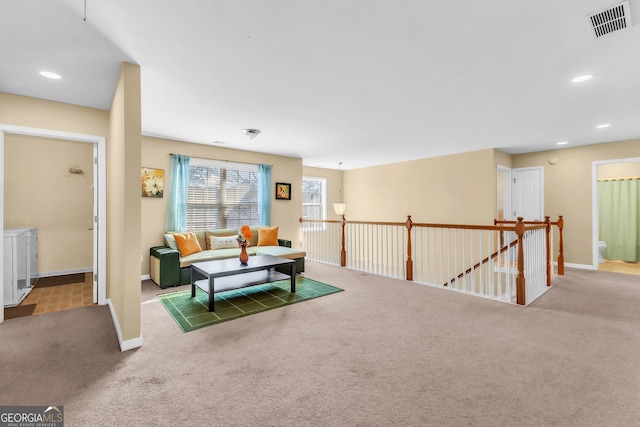 living room with light colored carpet and washer and dryer