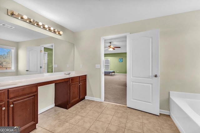 bathroom with vanity, a washtub, tile patterned floors, and ceiling fan