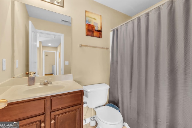 bathroom featuring vanity and toilet