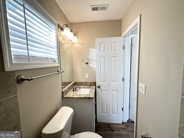 bathroom featuring vanity and toilet