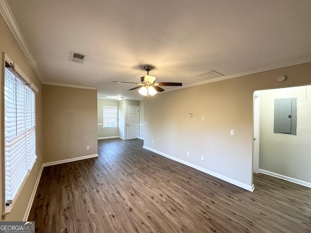 empty room featuring ceiling fan, ornamental molding, dark hardwood / wood-style floors, and electric panel