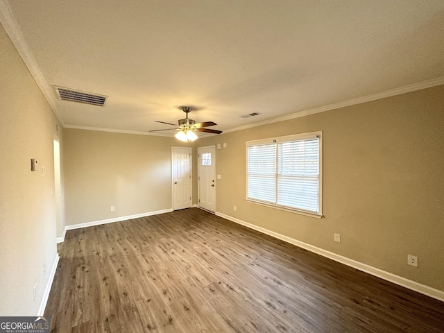 spare room with crown molding, dark hardwood / wood-style floors, and ceiling fan