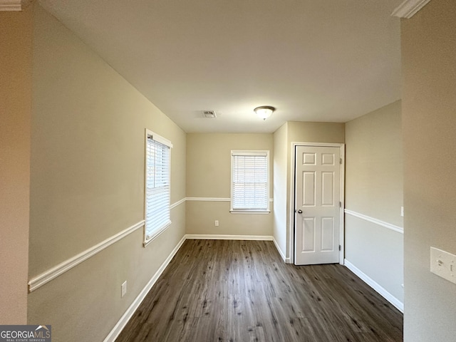 empty room with dark wood-type flooring