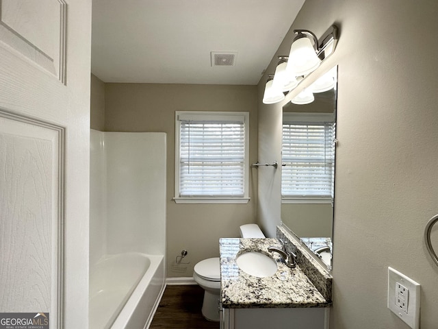 bathroom with hardwood / wood-style flooring, vanity, and toilet