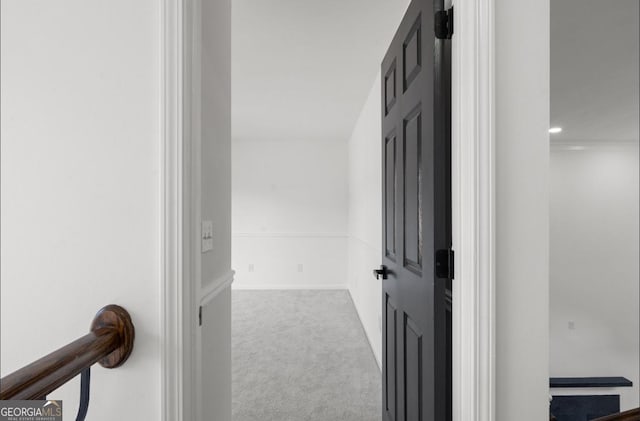 corridor featuring light colored carpet