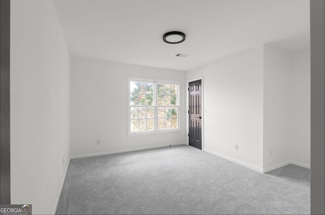 unfurnished room featuring light colored carpet