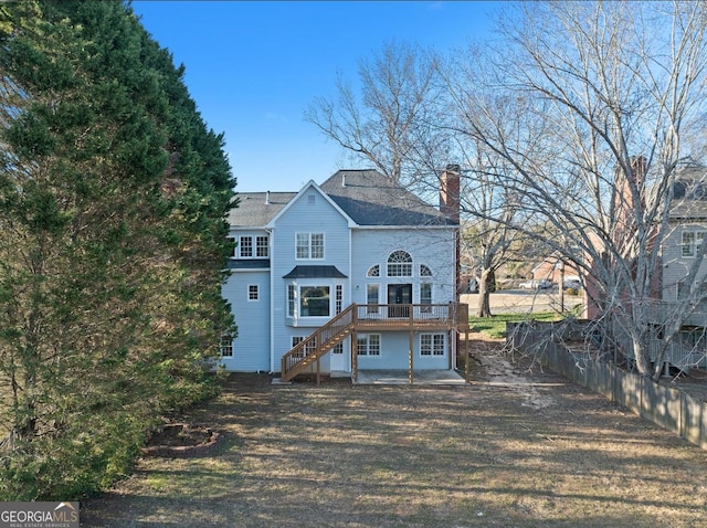 rear view of property featuring a wooden deck