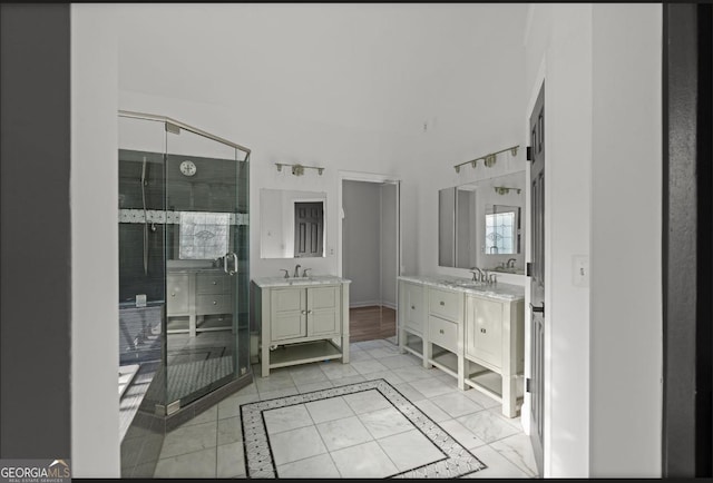 bathroom featuring vanity, a shower with shower door, and tile patterned floors