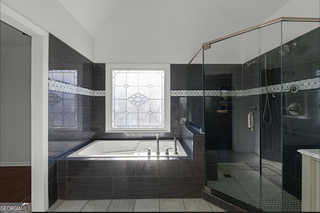 bathroom with tile patterned floors and shower with separate bathtub