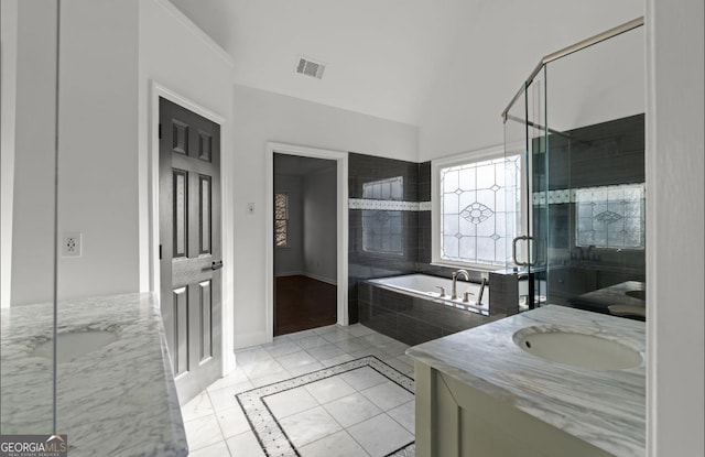 bathroom featuring vanity, tile patterned floors, and plus walk in shower