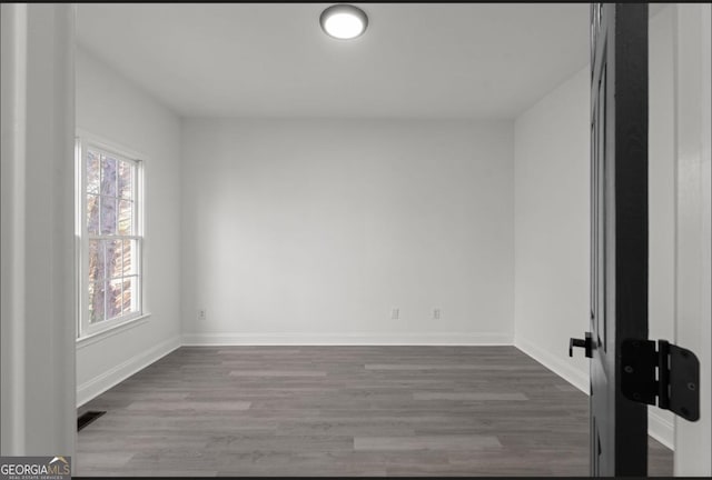 spare room featuring dark hardwood / wood-style flooring