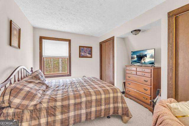 bedroom with a textured ceiling and carpet