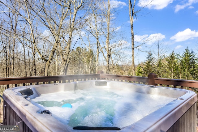 wooden deck featuring a hot tub