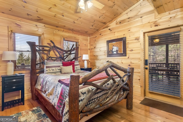 bedroom with wood ceiling, wood-type flooring, wooden walls, and vaulted ceiling