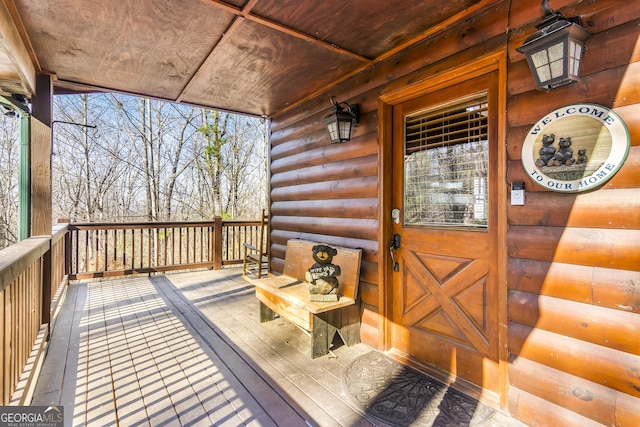 wooden terrace featuring covered porch